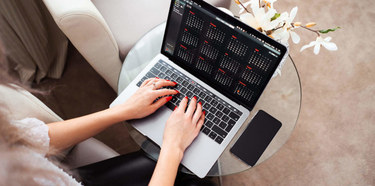 Young Woman Working/Typing on Her Laptop